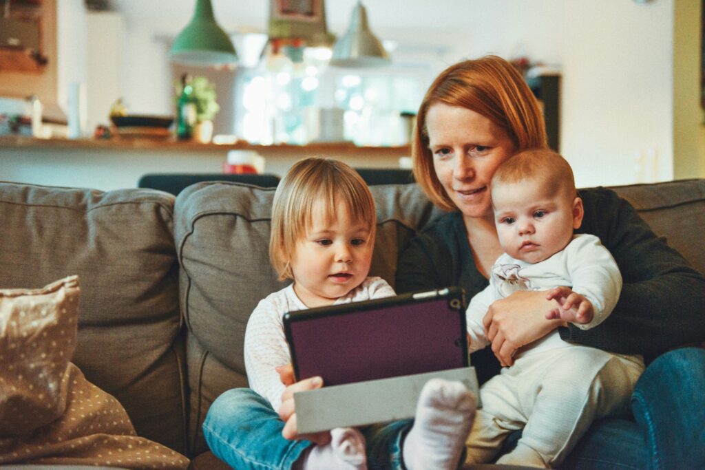 family sitting on couch reading a book