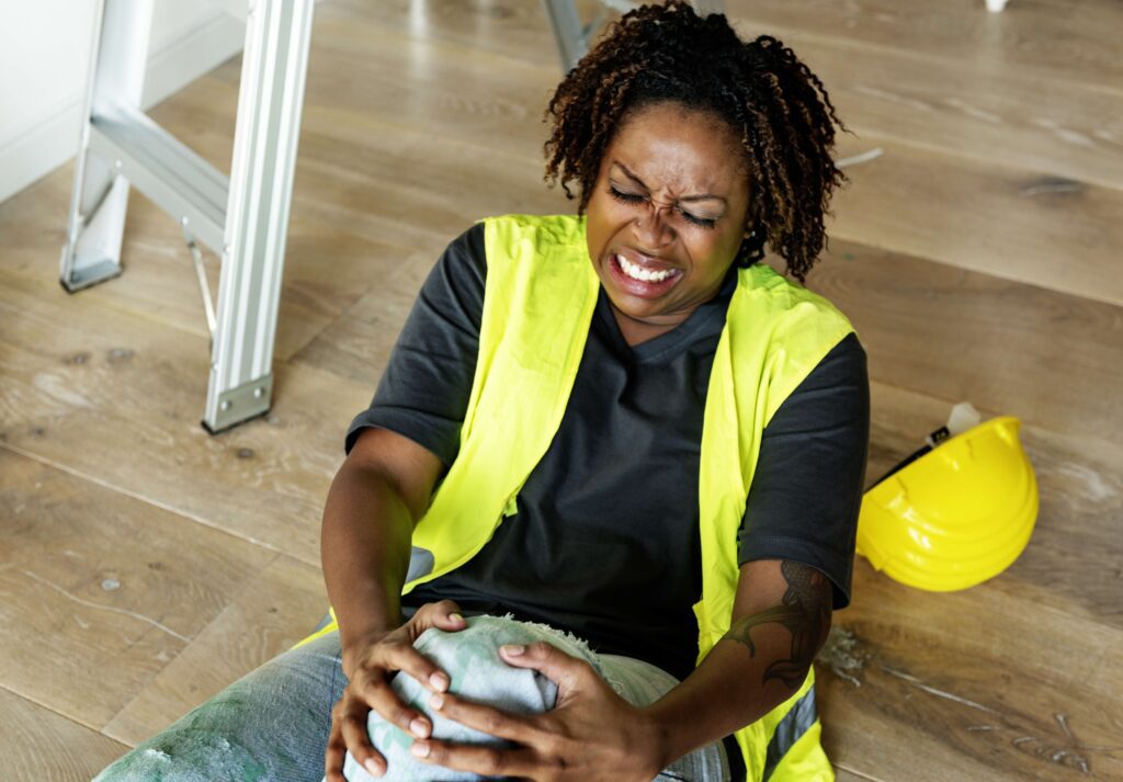 A person getting injured and holding knee